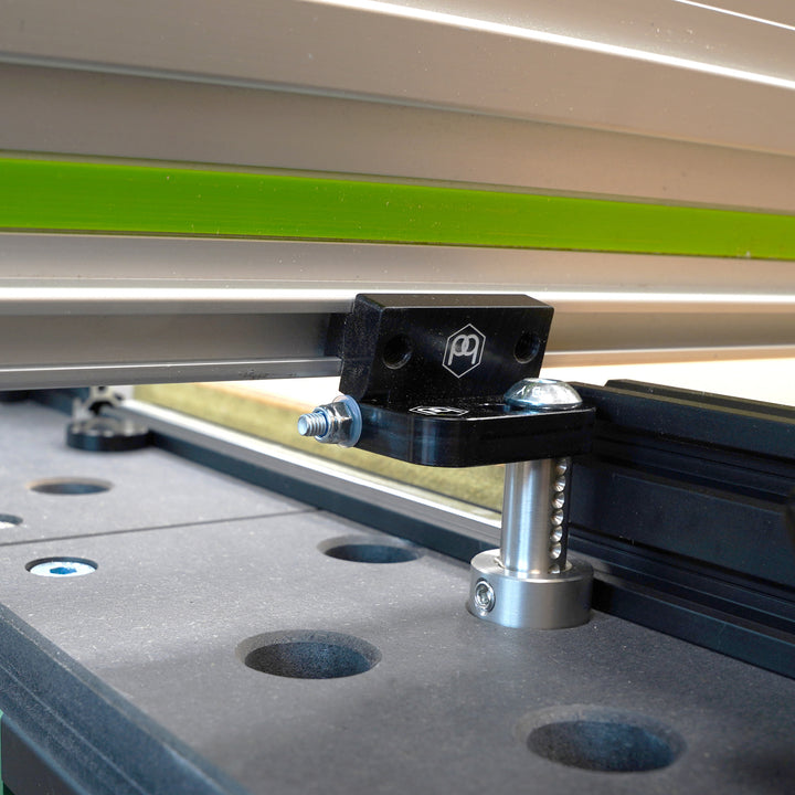 Close-up of a router table with the Hinge Dog installed and folded